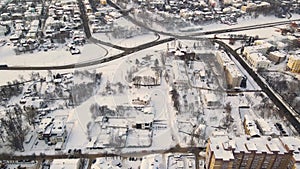 Aerial view of snowy urban residential area in winter.