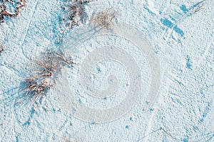 Aerial view of snowy wasteland with bare trees