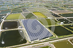 Aerial view of Solar panel farm on  fish pond for electricity generation