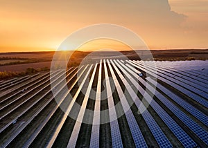 Aerial view on the solar panel. Technologies of renewable energy sources. View from air. Industrial landscape during sunset. photo