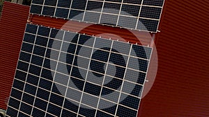 Aerial view of solar panels on a building roof. Fotovoltaic panels installation on factory rooftop