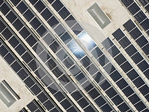 Aerial View of Solar Panels Mounted on Roof of Large Industrial Building or Warehouse