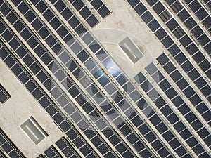 Aerial View of Solar Panels Mounted on Roof of Large Industrial Building or Warehouse