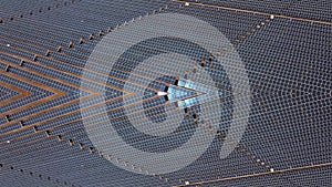 Aerial view of solar panels with sun reflection at the warm heat desert. Green power, ecology, clean alternative energy