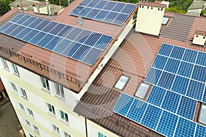 Aerial view of solar power plant with blue photovoltaic panels mounted of apartment building roof