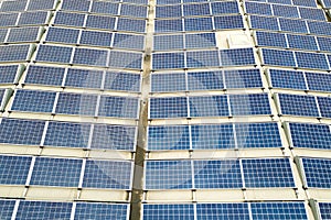 Aerial view of solar power plant with blue photovoltaic panels mounted of industrial building roof