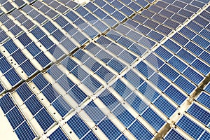 Aerial view of solar power plant with blue photovoltaic panels mounted of industrial building roof