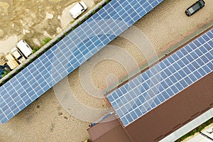 Aerial view of solar power plant with blue photovoltaic panels mounted of industrial building roof