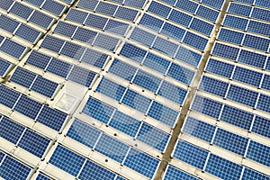 Aerial view of solar power plant with blue photovoltaic panels mounted of industrial building roof