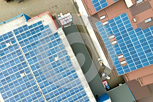 Aerial view of solar power plant with blue photovoltaic panels mounted of industrial building roof