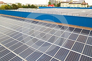 Aerial view of solar power plant with blue photovoltaic panels mounted of industrial building roof