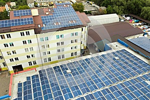 Aerial view of solar power plant with blue photovoltaic panels mounted of industrial building roof