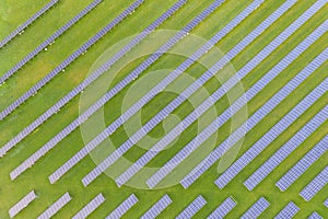 Aerial view of solar power plant on green field. Electric panels for producing clean ecologic energy. Solar cell field. megawatt