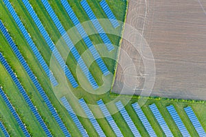 Aerial view of solar power plant on green field. Electric panels for producing clean ecologic energy. Solar cell field. megawatt