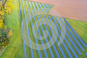 Aerial view of solar power plant on green field. Electric panels for producing clean ecologic energy. Solar cell field. megawatt photo