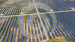 Aerial view of solar power plant on green field. Solar panels system for solar power generation. Green energy for sustainable