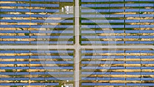 Aerial view of solar power plant on green field. Solar panels system for solar power generation. Green energy for sustainable