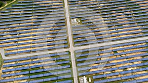 Aerial view of solar power plant on green field. Solar panels system for solar power generation. Green energy for sustainable