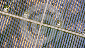 Aerial view of solar power plant on green field. Solar panels system for solar power generation. Green energy for sustainable