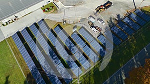 Aerial view of solar power plant with photovoltaic panels mounted on industrial building grounds for producing green