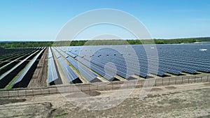 Aerial view of solar power station field at sunny day. Aerial Top View of Solar Farm. Renewable energy technology. Wide