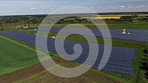Aerial view on the solar power station with long rows of the solar panels, 4k