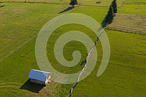 Aerial view of some mountain farm gardens and lawns in the middle of summer during a beautiful day shot in Romania Bucovina