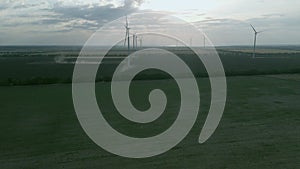 Aerial view of some operating air turbines in a field off the coast