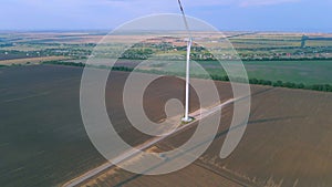 Aerial view of some operating air turbines in the middle of the cultivated field