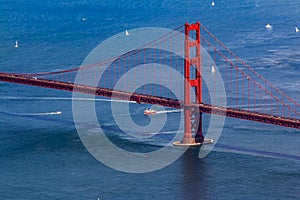 Aerial view of the South tower of Golden Gate Bridge and yachts on the bay, fly over San Francisco, USA