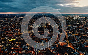 Aerial view of south west London, blue hour just after sunset, orange yellow street lights starting to glow