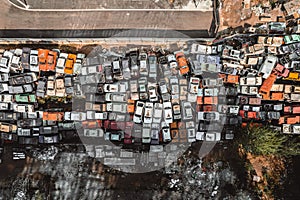 Aerial view of a Soviet automobile dump from a drone. Shooting from above at heaps of rusty cars. Abandoned Russian cars