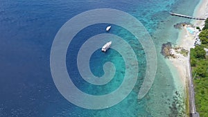 Aerial view of speed boat and beautiful sea beach at top view on summer, Luxury island paradise for tourism travel on