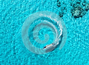 Aerial view of the speed boat in clear blue water on summer sunny day