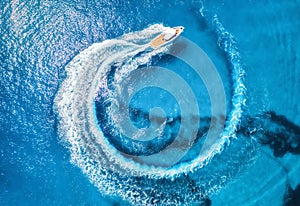 Aerial view of the speed boat in clear blue water at sunny day