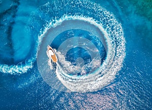 Aerial view of the speed boat in clear blue water at sunset