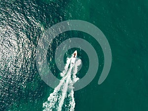 Aerial view of Speed boat at high speed in the aqua sea, Drone view.