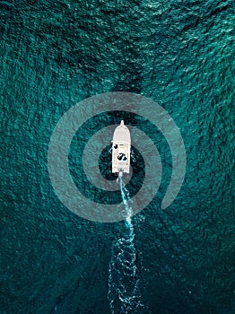 Aerial view of speed boat in motion in blue sea in Italy