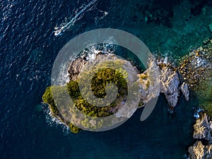 Aerial view of a speedboat hurtling near the island of Sveti Nikola, island of Budva, Montenegro. Jagged coasts