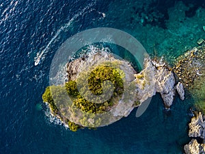 Aerial view of a speedboat hurtling near the island of Sveti Nikola, island of Budva, Montenegro. Jagged coasts