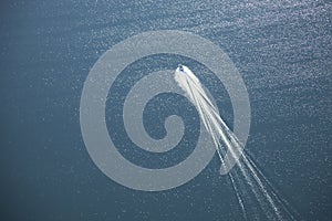 Aerial view of speedboat leaving white wake on a lake