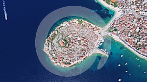 Aerial view of speedboat passing Primosten peninsula, Croatia