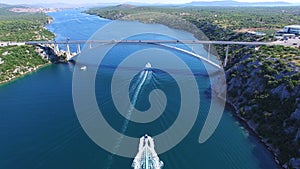 Aerial view of speedboats approaching bridge over dalmatian canal, Croatia