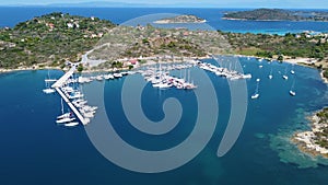 Aerial view of speedboats and motorboats docked in harbor. Beautiful blue sea with harbor and ships