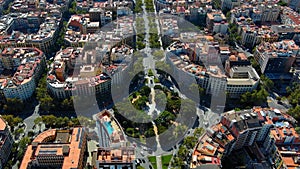 Aerial view of square buildings and traffic moving through Barcelona streets