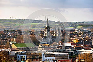 Aerial view of St Fin Barre cathedral with mountains in Cork, Ireland