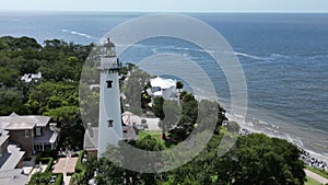 Aerial view of the St. Simons Island lighthouse and a beautiful beach on a sunny day