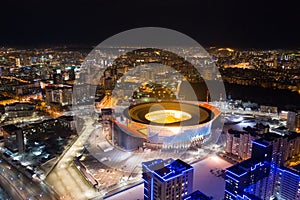 Aerial view of stadium with night illumination and residential buildings in the center of Yekaterinburg. Russia