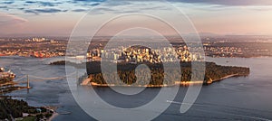 Aerial View of Stanley Park and Downtown Vancouver City on Ocean Coast. Sunset