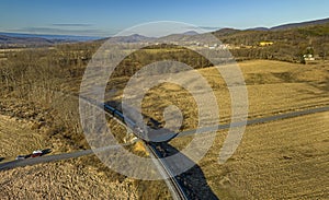 Aerial View of a Steam Passenger Train Rounding a Curve, Blowing Smoke and Steam